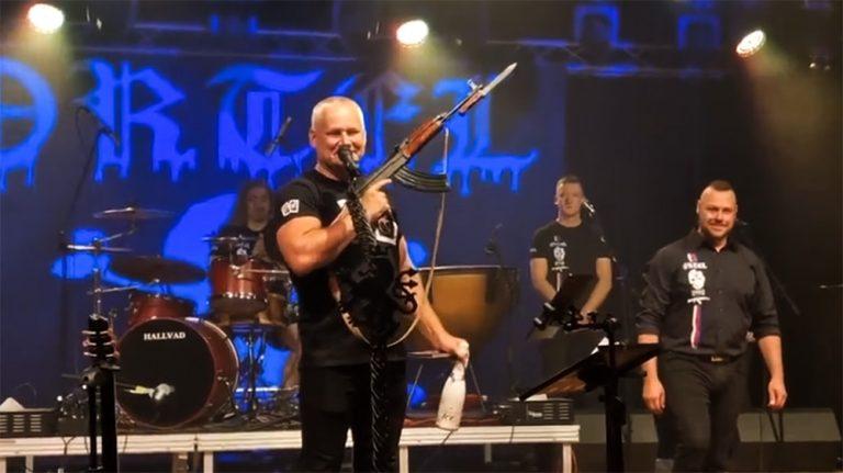 Convicted Czech murderer Kajínek holding a machine gun at the launch of the new album by the xenophobic group Ortel.